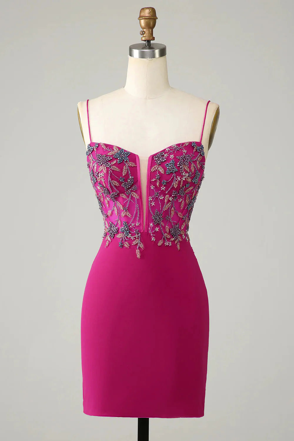 Fuchsia bodycon short homecoming dress with spaghetti straps and beaded details.