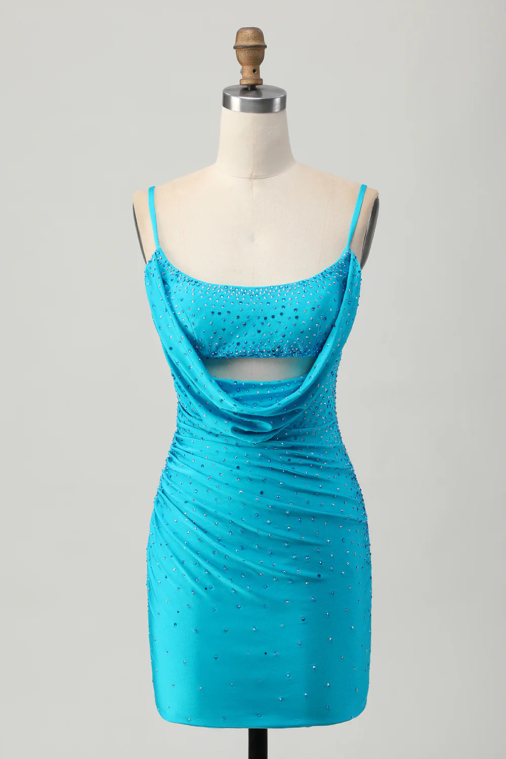 Model wearing a tight blue short homecoming dress with cut-out detail and beading.