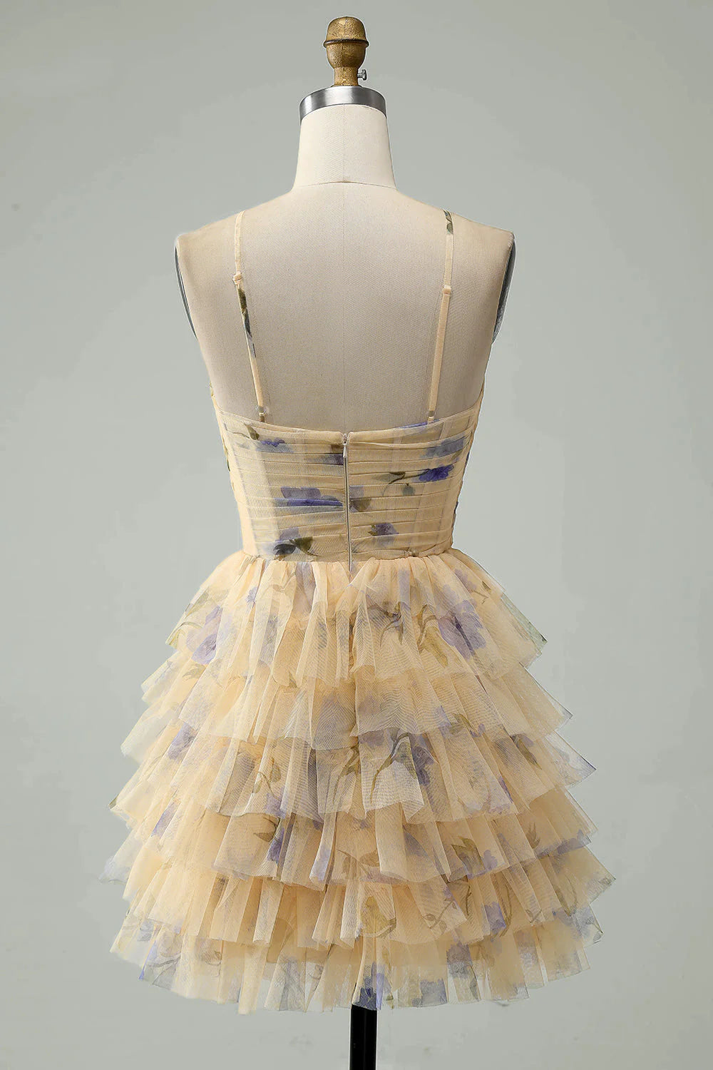 Side view of a yellow floral A-line halter tiered short dress.