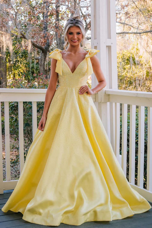 A-line beaded ball gown with suspender bow and deep V-floor skirt