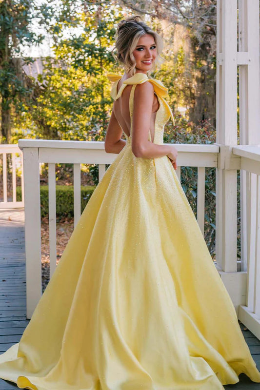 A-line beaded ball gown with suspender bow and deep V-floor skirt