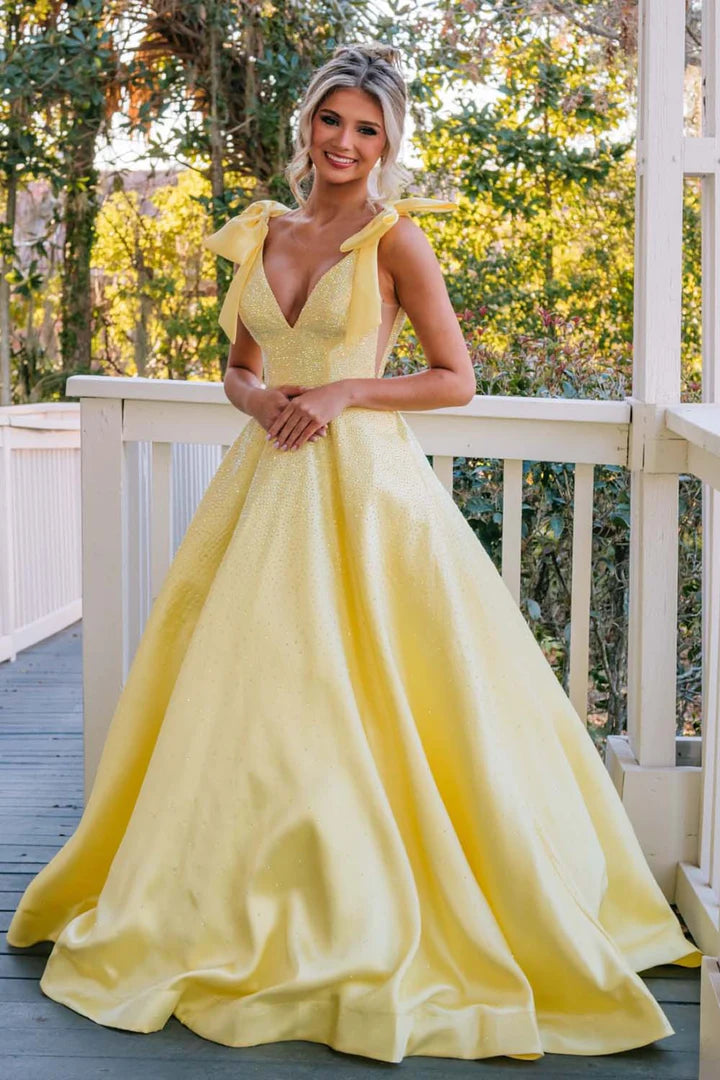 A-line beaded ball gown with suspender bow and deep V-floor skirt